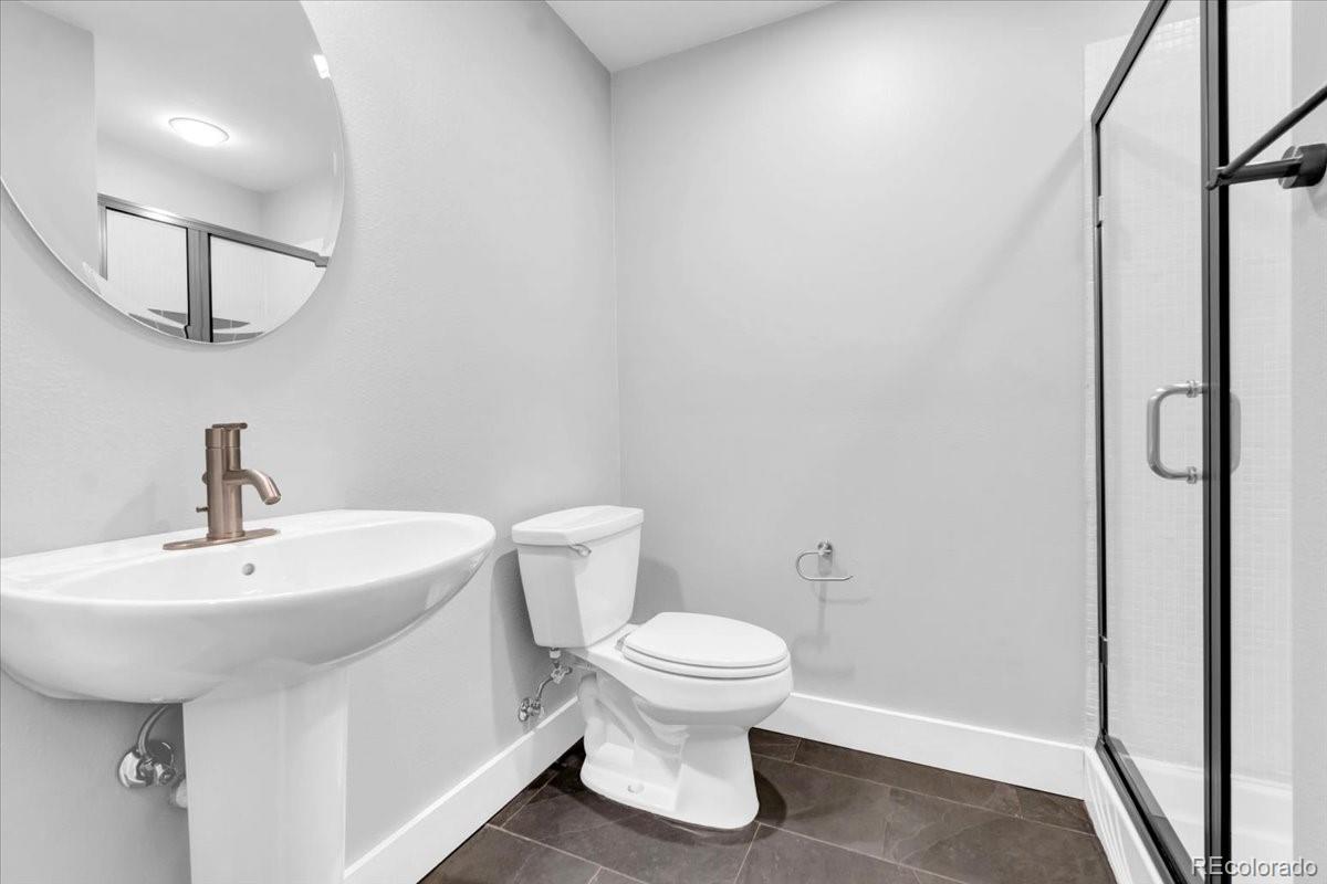 2900 Inca Street, Unit 15 Denver, CO 80202 - Photo 10 of 40 a bathroom with a sink toilet and a mirror