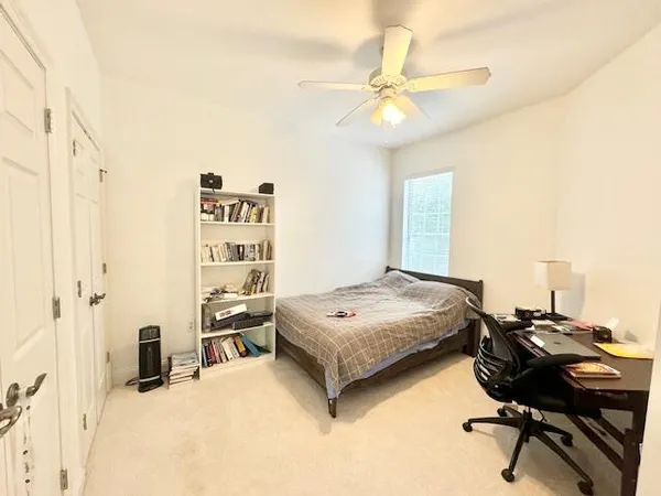 a bedroom with a bed and a desk