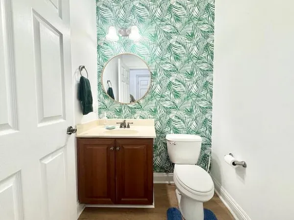 a bathroom with a toilet sink and mirror