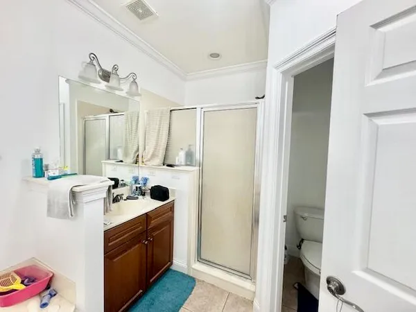 a bathroom with a double vanity sink mirror and toilet