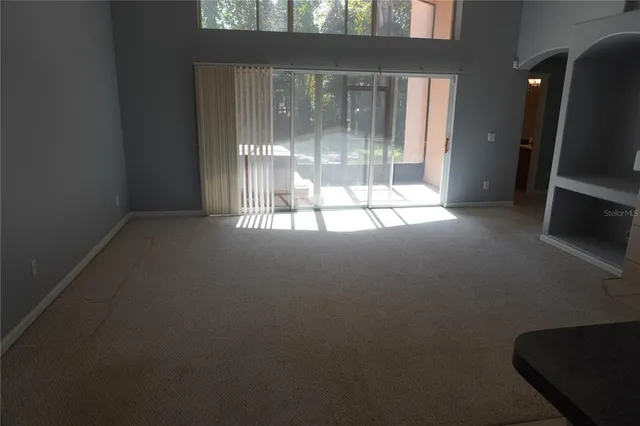 a view of empty room with floor to ceiling window