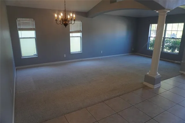 an empty room with windows and entrance