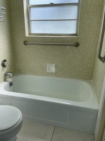 a bathroom with a shower and a bathtub
