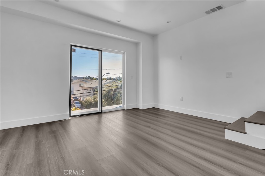 1571 Ricardo Street Los Angeles, CA 90033 - Photo 11 of 19 a view of an empty room with wooden floor and a window