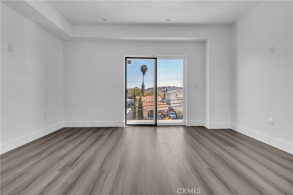 1571 Ricardo Street Los Angeles, CA 90033 - Photo 12 of 19 a view of an empty room with wooden floor and a window