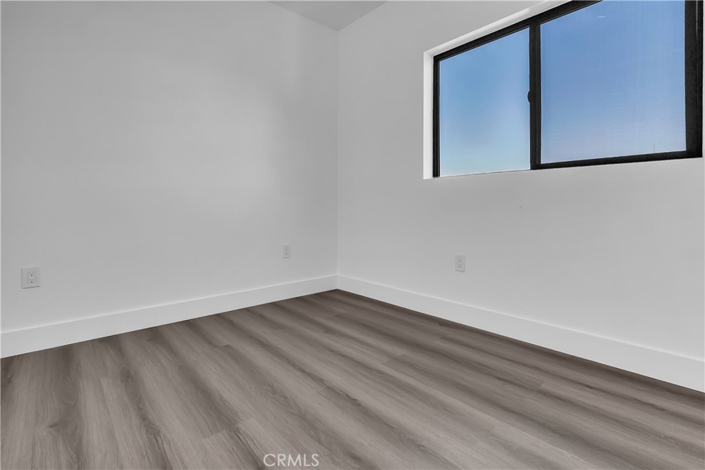 1571 Ricardo Street Los Angeles, CA 90033 - Photo 17 of 19 a view of an empty room with wooden floor and a window