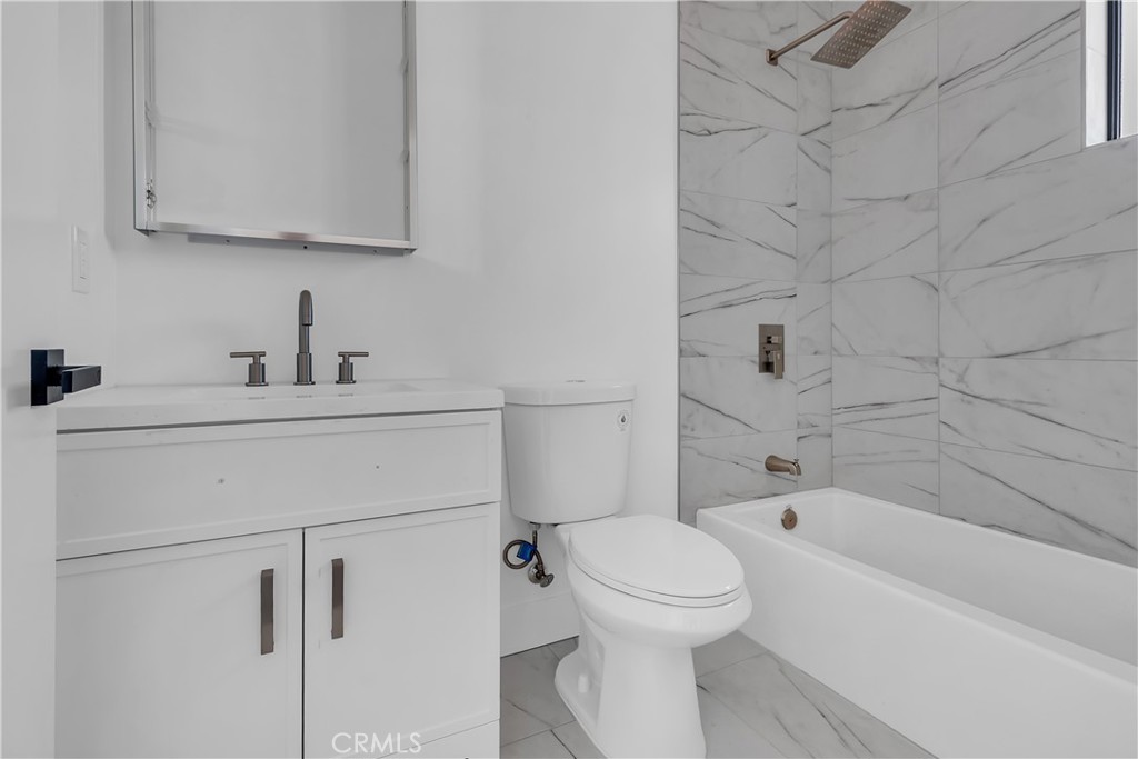 1571 Ricardo Street Los Angeles, CA 90033 - Photo 9 of 19 a bathroom with a sink toilet and bathtub