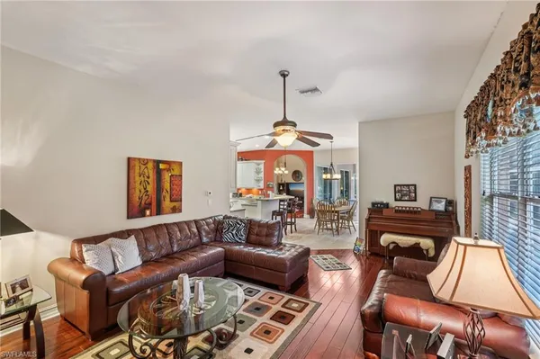 a living room with furniture and a wooden floor