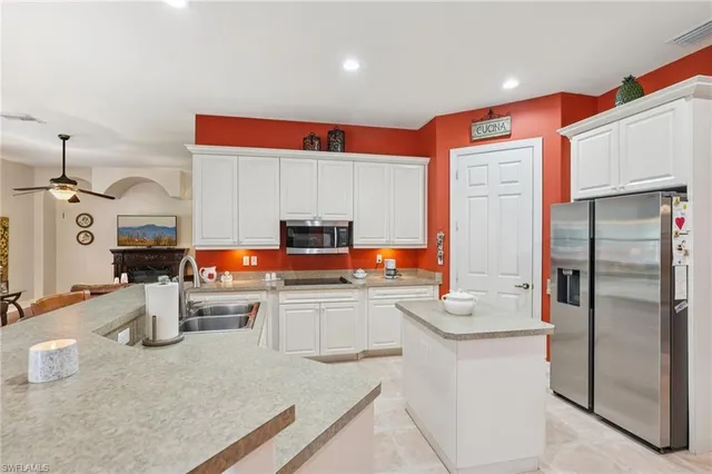 a kitchen with stainless steel appliances granite countertop a sink stove and cabinets