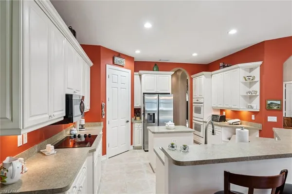 a kitchen with stainless steel appliances a refrigerator sink and stove