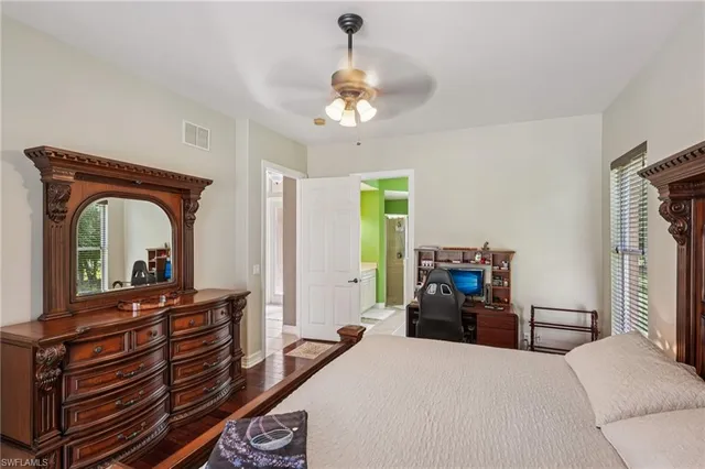 a bedroom with a bed and a large window with balcony view