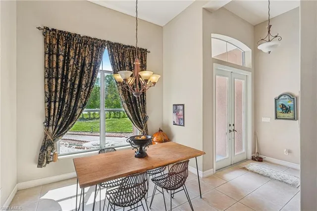 a dining room with chandelier fan and wooden floor