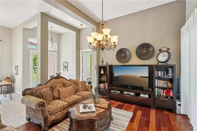 a living room with furniture and a chandelier