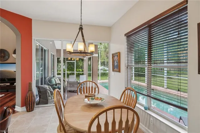 a living room with furniture a flat screen tv and a floor to ceiling window
