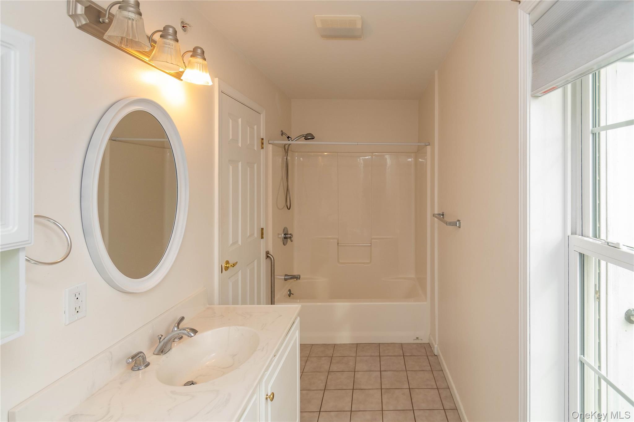 70 Aveonis Court Fishkill, NY 12524 - Photo 12 of 19 Full bath with vanity, tub / shower combination, and light tile patterned floors