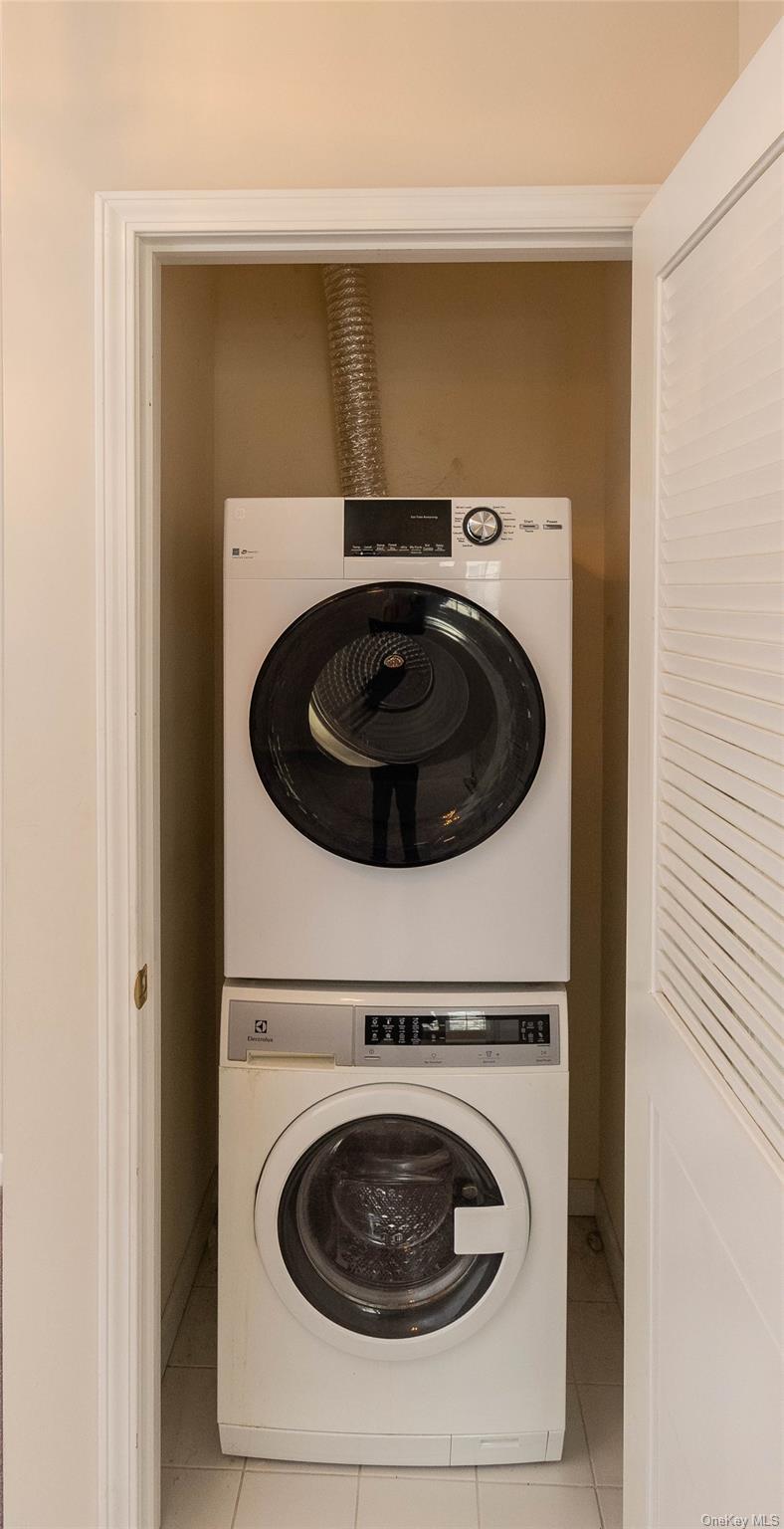 70 Aveonis Court Fishkill, NY 12524 - Photo 14 of 19 Washroom with stacked washer / drying machine and light tile patterned flooring