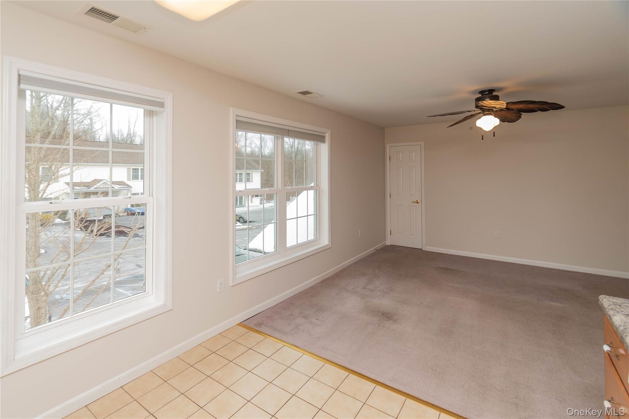 70 Aveonis Court Fishkill, NY 12524 - Photo 8 of 19 Empty room featuring light colored carpet, ceiling fan, and light tile patterned floors