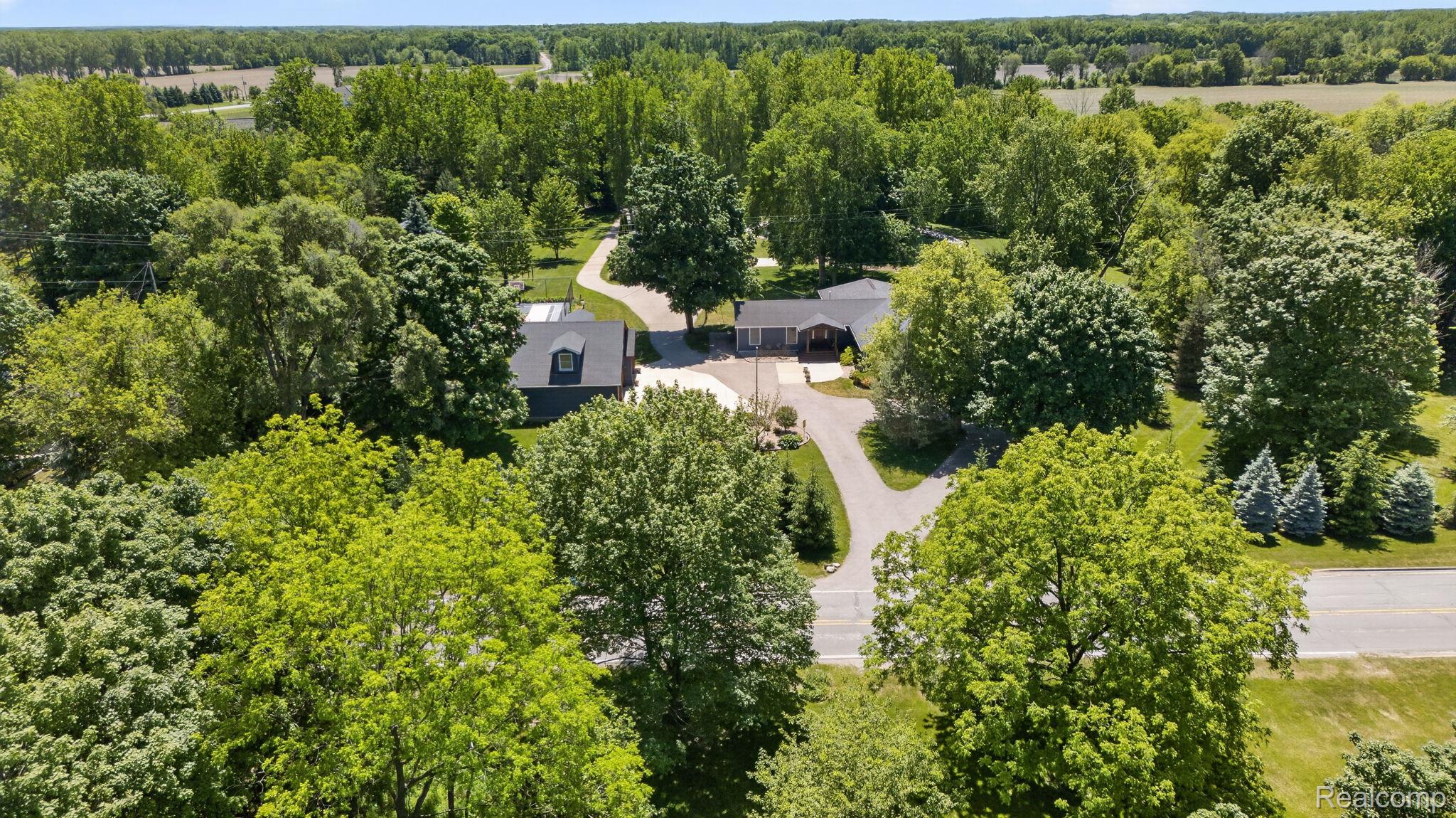 9353 Hill Road Swartz Creek, MI 48473 - Photo 93 of 98 Expansive property featuring a main residence and an additional structure, both surrounded by mature trees