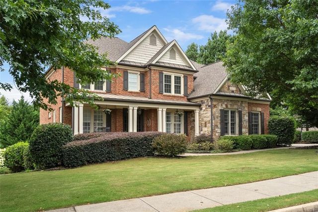 a front view of a house with a garden