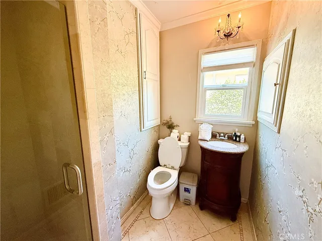 a bathroom with a toilet sink and a shower curtain