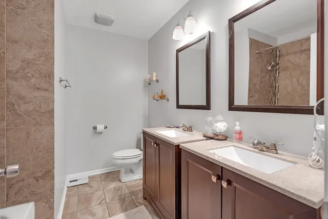 a bedroom with a bed and painting on the wall