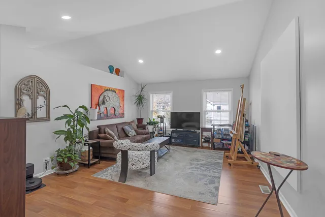 a living room with furniture and a wooden floor