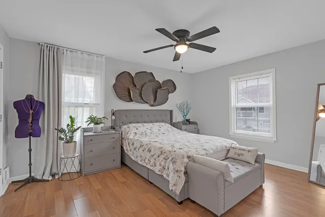 a bedroom with a bed potted plant with the outer view