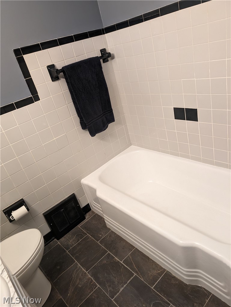 30213 Barjode Road Willowick, OH 44095 - Photo 6 of 20 Bathroom with tile flooring, toilet, and tile walls