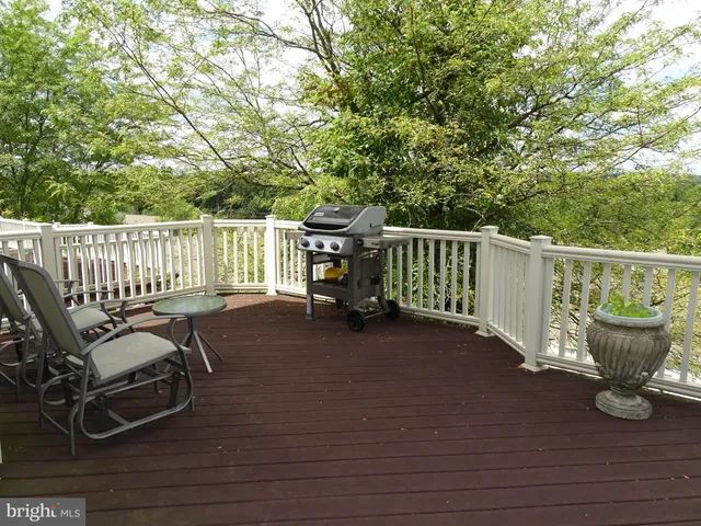 a view of a chair and table on the wooden deck