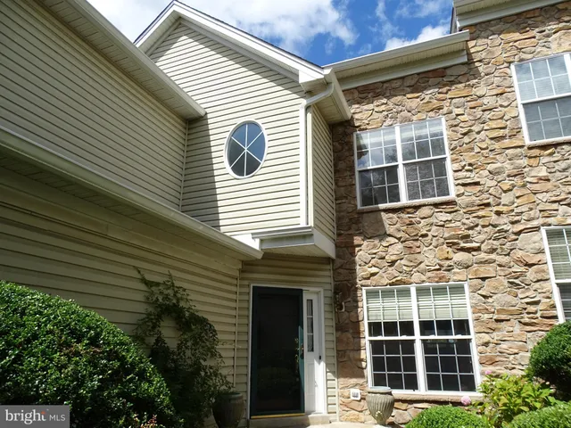 a view of a brick house with large windows