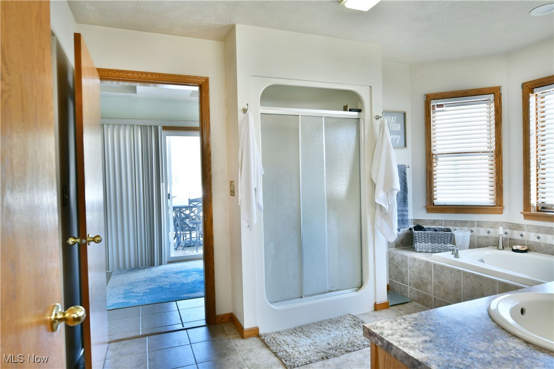 5915 Downs Road Northwest Warren, OH 44481 - Photo 14 of 50 Bathroom with tile patterned flooring, vanity, a wealth of natural light, and walk in shower