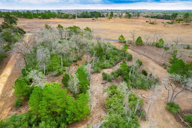a view of a lake with beach and green space