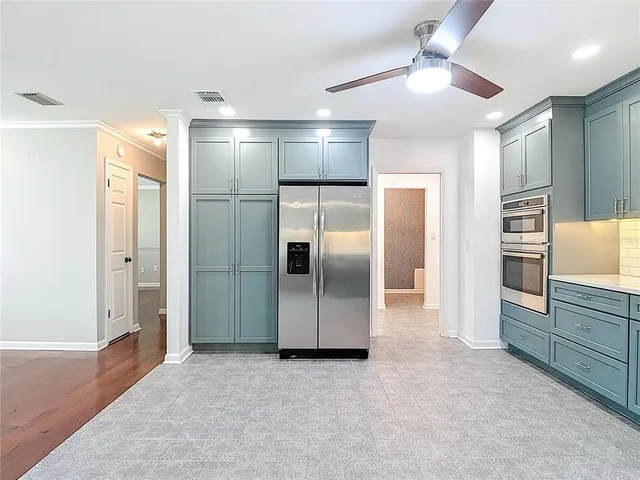 a bathroom with a granite countertop toilet a sink and mirror
