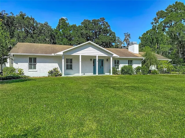 a front view of a house with a garden and porch
