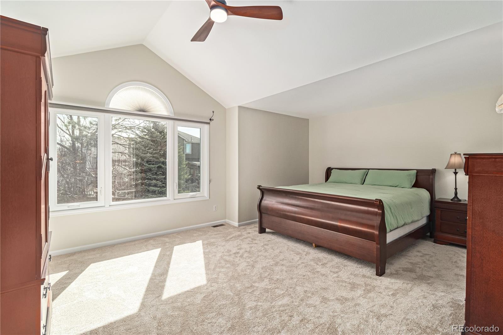 10152 Knoll Circle Highlands Ranch, CO 80130 - Photo 15 of 34 a bedroom with a bed lamp and window