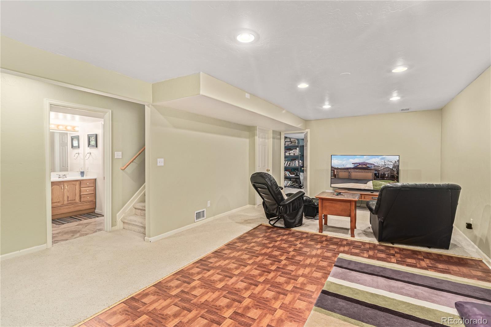 10152 Knoll Circle Highlands Ranch, CO 80130 - Photo 20 of 34 a living room with furniture and a rug