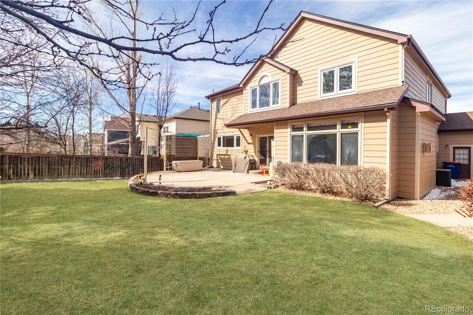 10152 Knoll Circle Highlands Ranch, CO 80130 - Photo 22 of 34 a view of a house with a yard and a tree