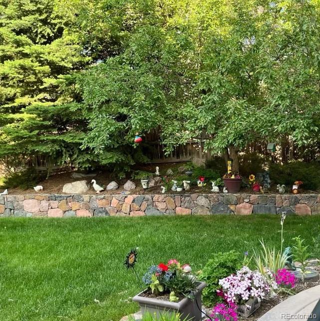10152 Knoll Circle Highlands Ranch, CO 80130 - Photo 28 of 34 a view of yard with seating area and trees