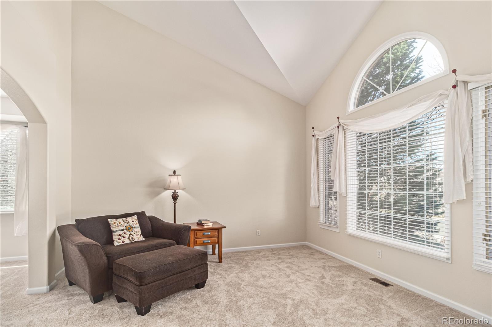 10152 Knoll Circle Highlands Ranch, CO 80130 - Photo 5 of 34 a living room with furniture and a window