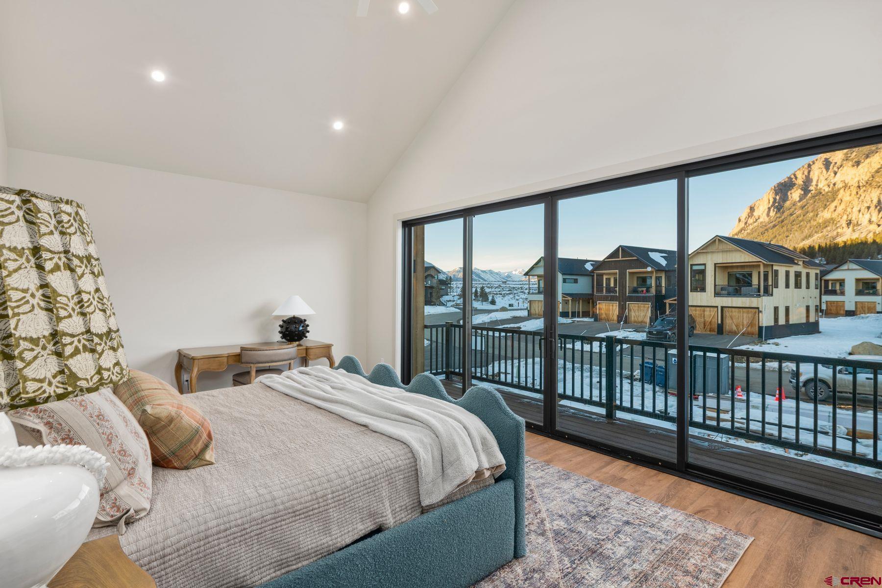 180 Elk Valley Road, Unit 116 Crested Butte, CO 81224 - Photo 11 of 26 a bedroom with double bed and a large window