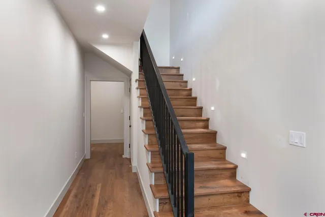 a view of entryway and gallery with wooden floor