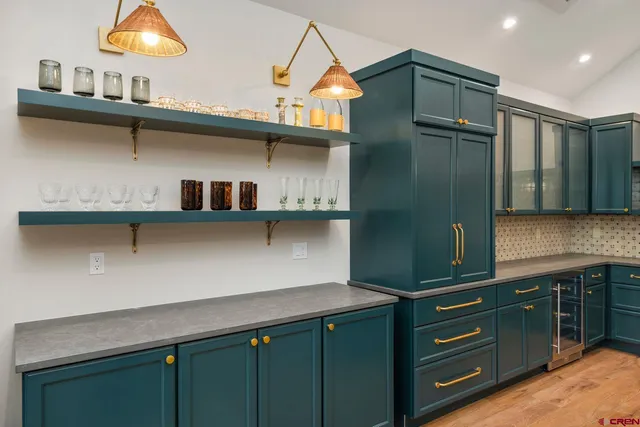 a kitchen with stainless steel appliances a cabinets and wooden floor