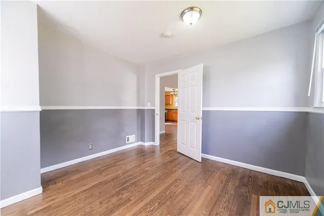 an empty room with wooden floor