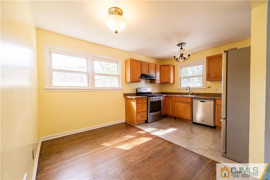16 Homes Street Edison, NJ 08817 - Photo 16 of 21 a kitchen with granite countertop a sink cabinets and stainless steel appliances