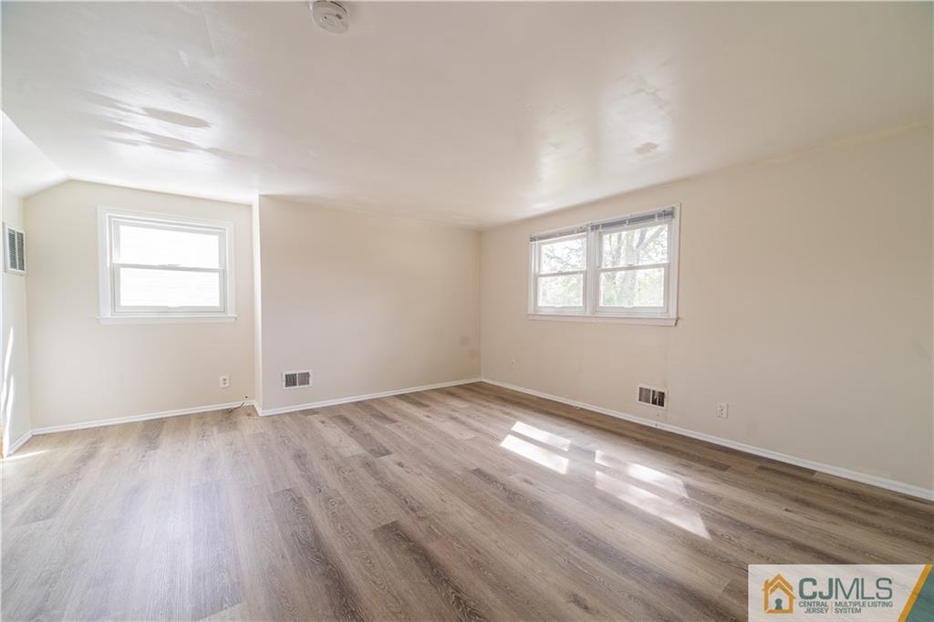 16 Homes Street Edison, NJ 08817 - Photo 20 of 21 an empty room with wooden floor and windows