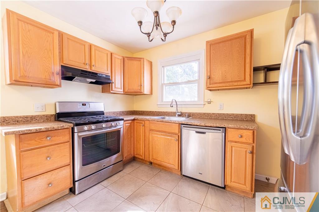 16 Homes Street Edison, NJ 08817 - Photo 2 of 21 a kitchen with stainless steel appliances granite countertop a stove a sink dishwasher and a refrigerator