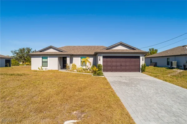 a front view of a house with a yard and garage