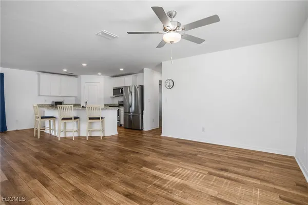 a view of kitchen with wooden floor and stainless steel appliances