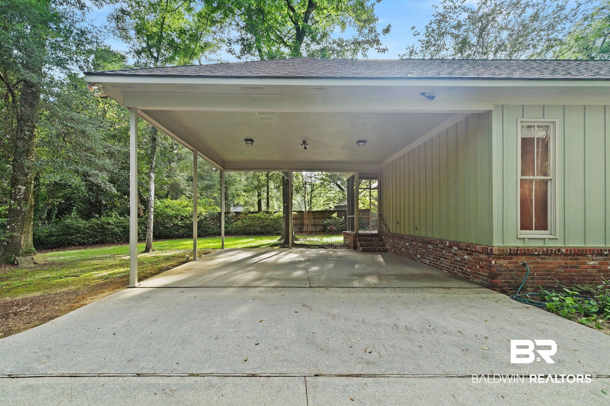 202 Beall Lane Daphne, AL 36526 - Photo 41 of 46 View of vehicle parking featuring a carport
