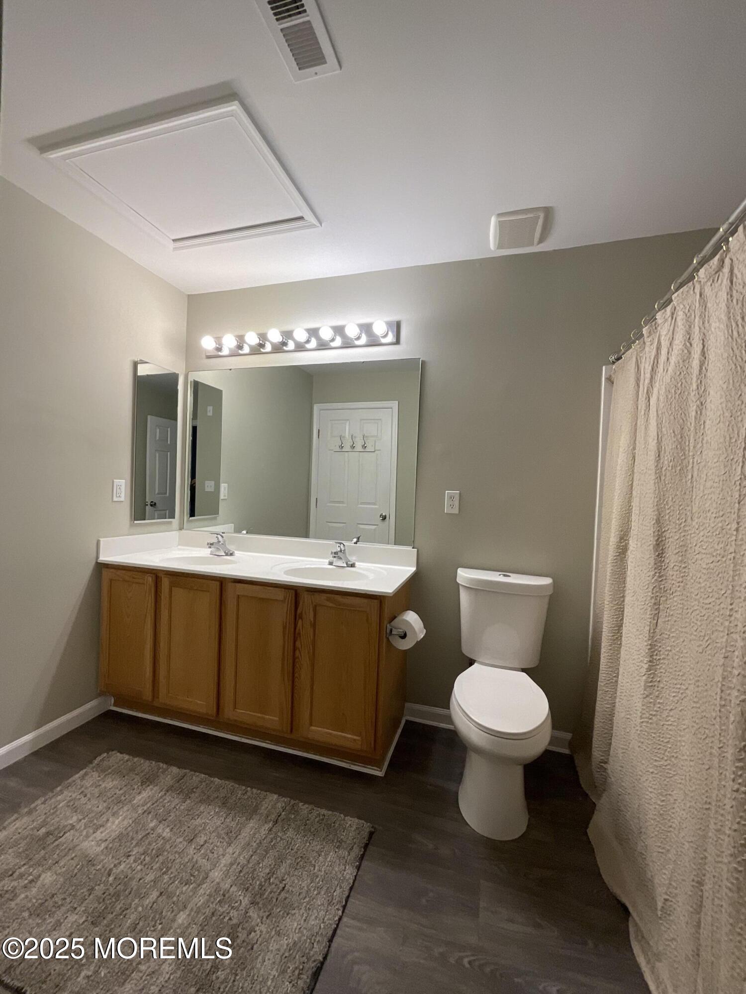 12 Abby Road, Unit 75 Farmingdale, NJ 07727 - Photo 15 of 20 a bathroom with a sink toilet a mirror and vanity